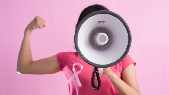 Strong woman flexing muscle with megaphone